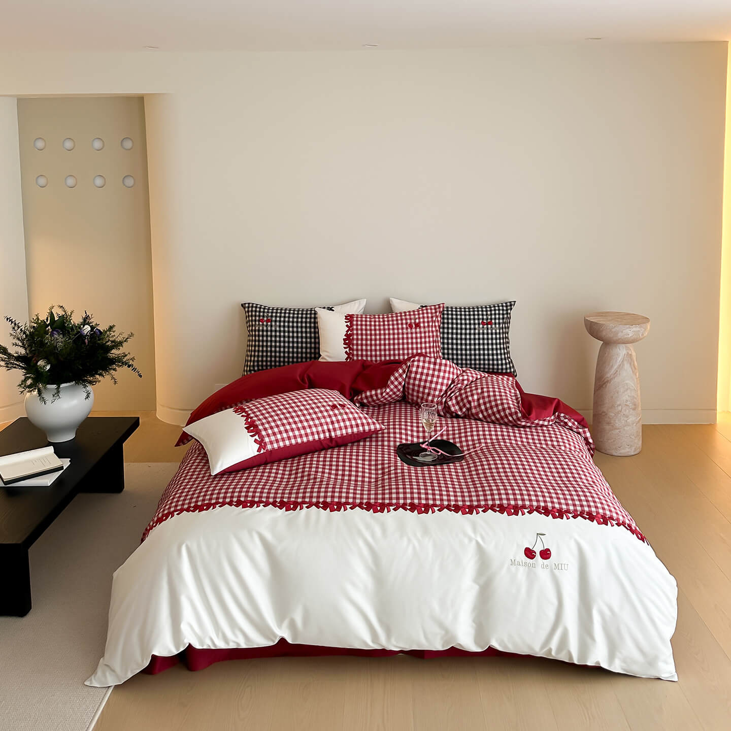 Modern bedroom with red and black gingham cotton bedding set, decorative pillows, and minimal decor
