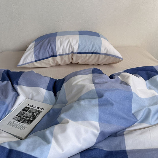 Blue plaid cotton bedding set with pillow and duvet on a bed, natural light, cozy look