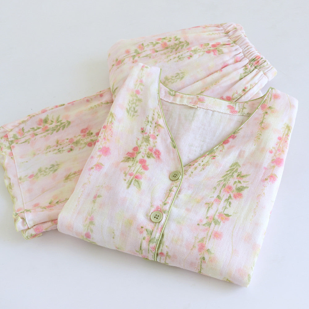 Floral cotton pajama set with pastel pink and green print, folded on white background