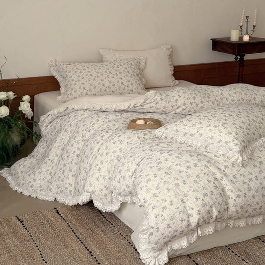 Ivory blue rose bedding set with ruffled pillowcases, flat sheet, and lace-trimmed duvet cover