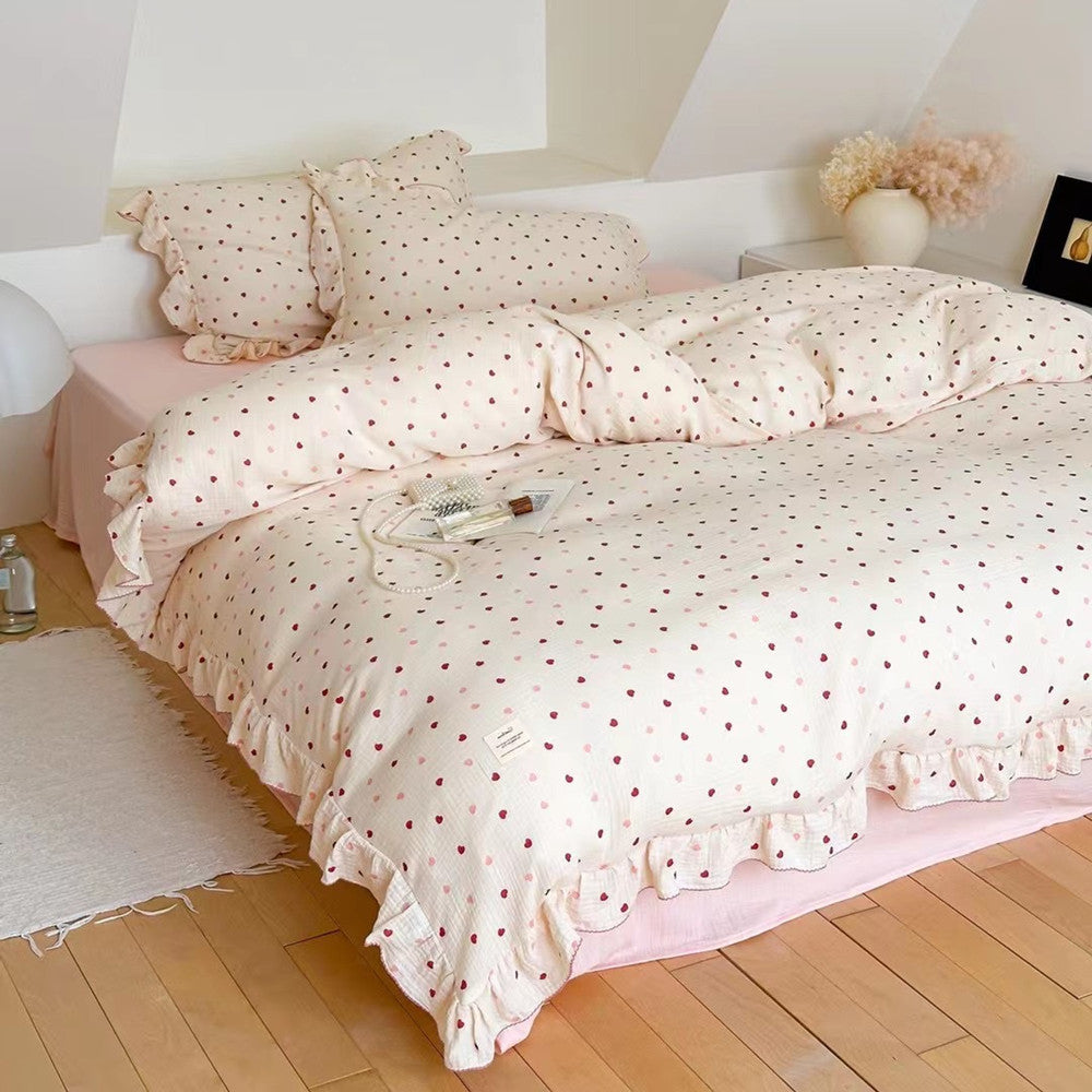 Girls Ruffle Duvet Cover Set in cotton, showcasing the heart print bedding and ruffle edges on a large bed.