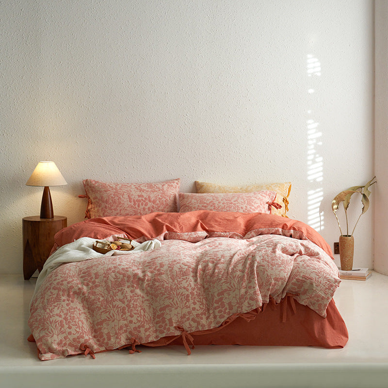 Full bed view of coral premium cotton floral jacquard bedding set, featuring tie closures.