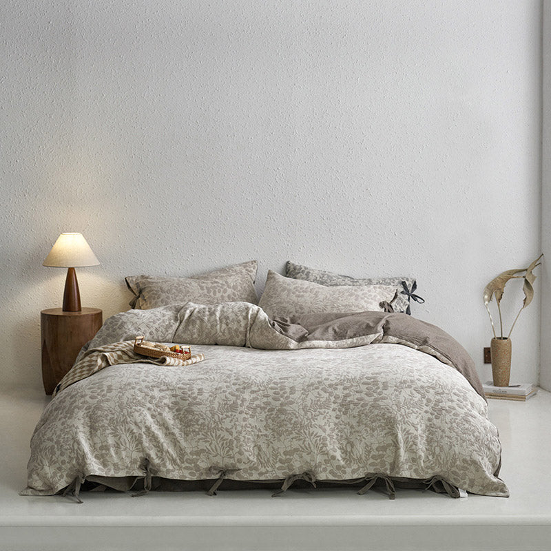 Wide full bed shot of the ash grey floral jacquard bedding set, premium cotton with tie closures.