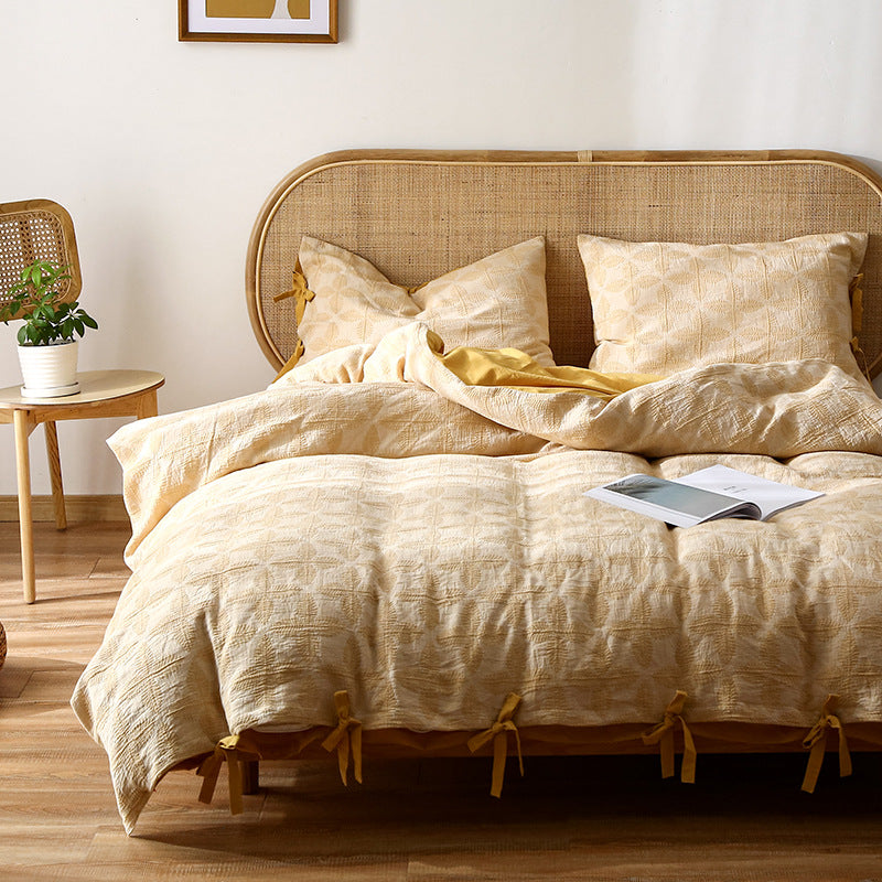 Queen Bed Duvet Cover Set in yellow jacquard with visible tie closures and natural wood furniture.