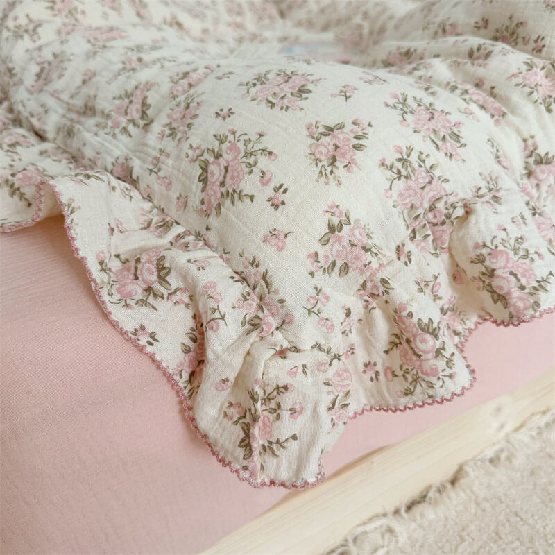 Close-up of the pink floral ruffle duvet draped over a pink sheet, highlighting the delicate fabric and ruffle design.