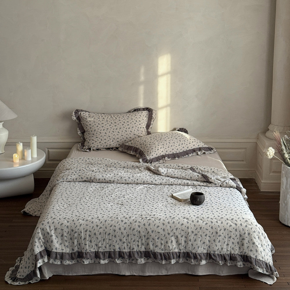 Bed with floral bedding in a softly lit bedroom