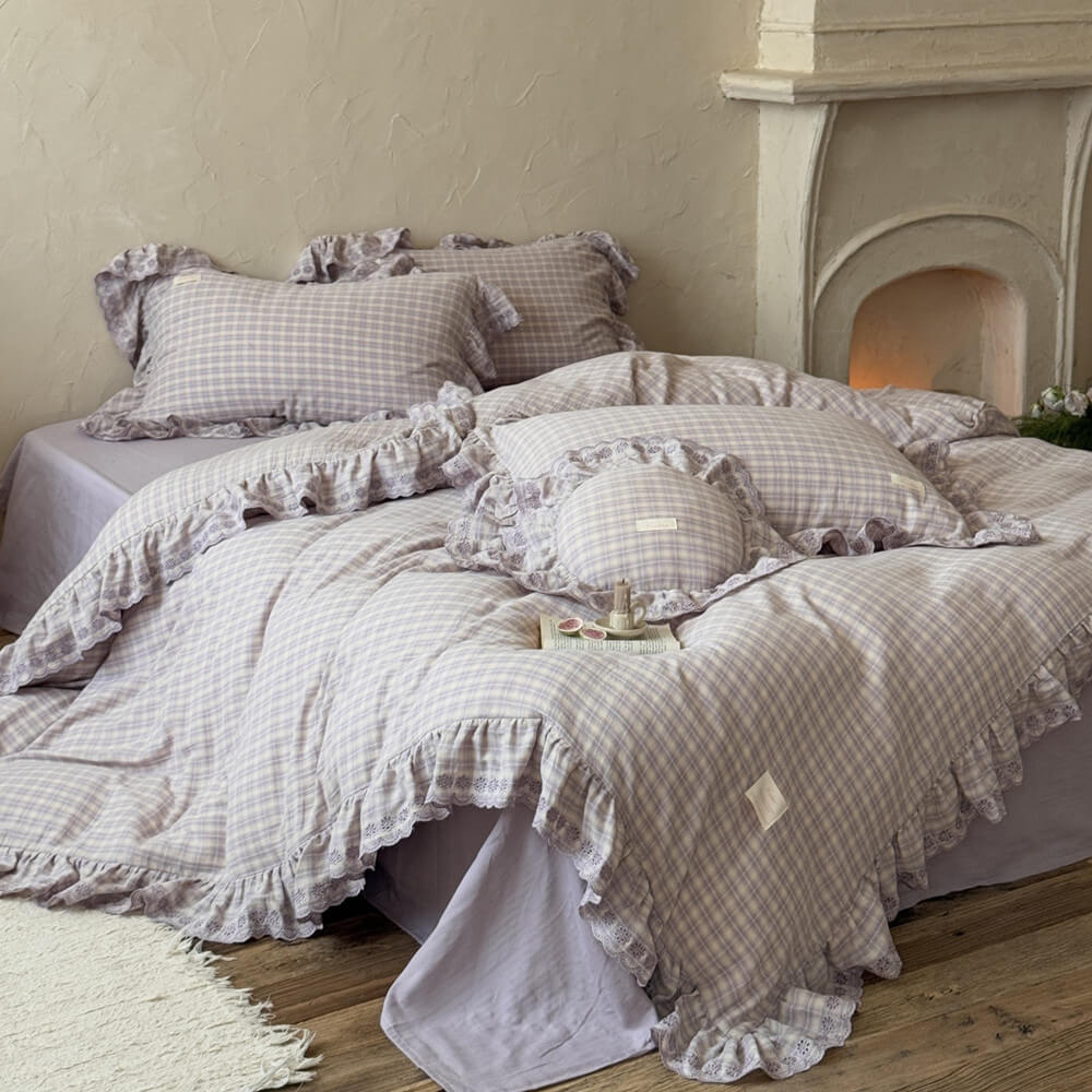 Lavender plaid ruffled duvet cover set styled on bed with matching pillowcases, soft cotton muslin