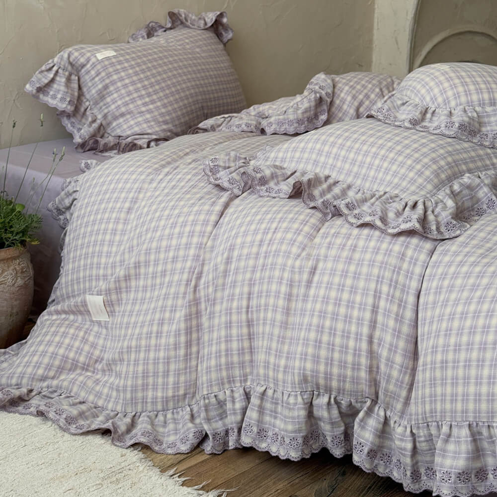 Side view of lavender plaid ruffled duvet cover set showing layered ruffled edges in a cottage-inspired bedroom