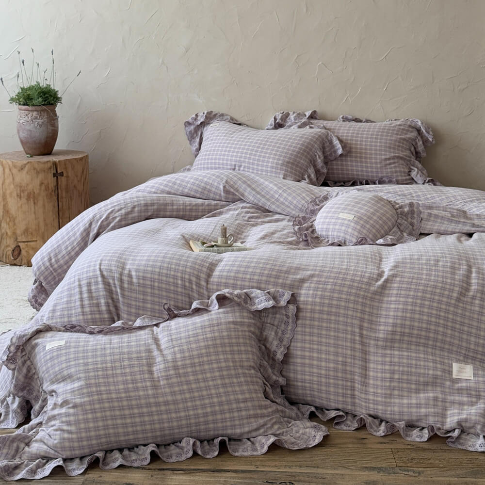 Lavender plaid duvet cover set with ruffled edges and lace trim, displayed in a rustic styled room