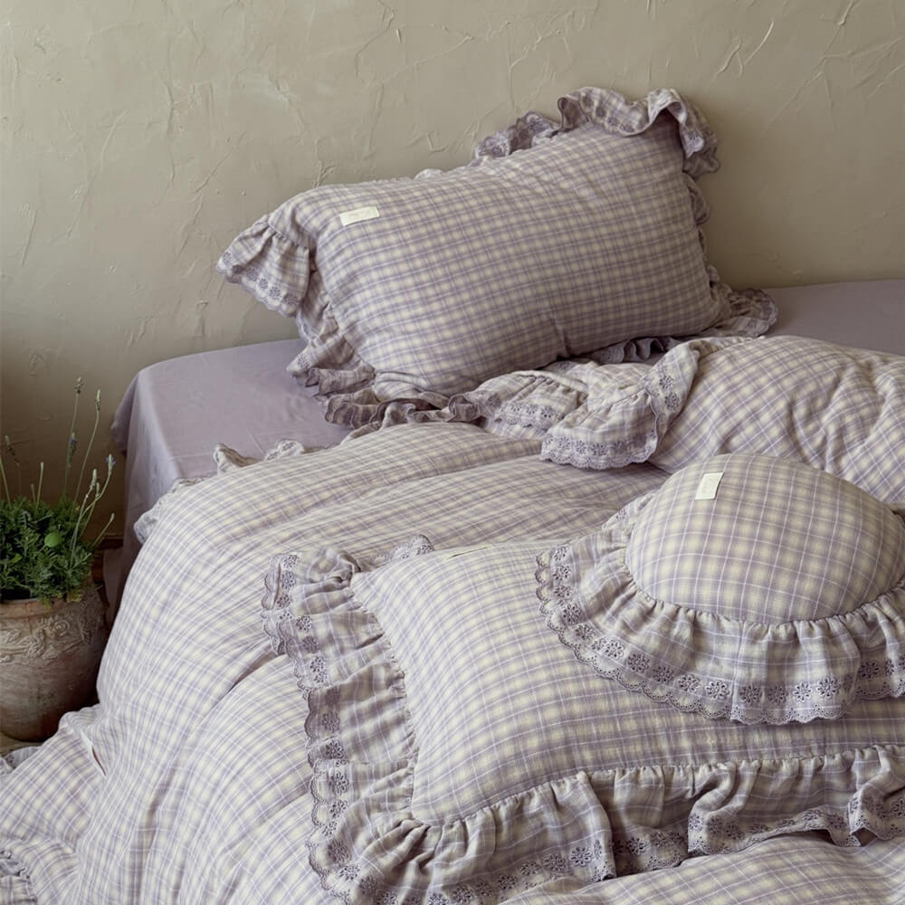 Close-up of ruffled pillow and duvet cover from lavender plaid cotton muslin duvet set