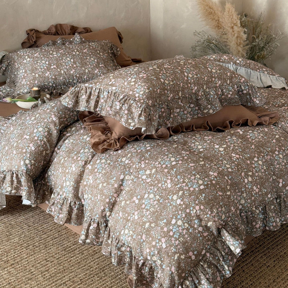 Close-up of the Earthy Floral Bedding Set in brown, highlighting the soft cotton muslin texture, delicate floral print, and ruffled edges.