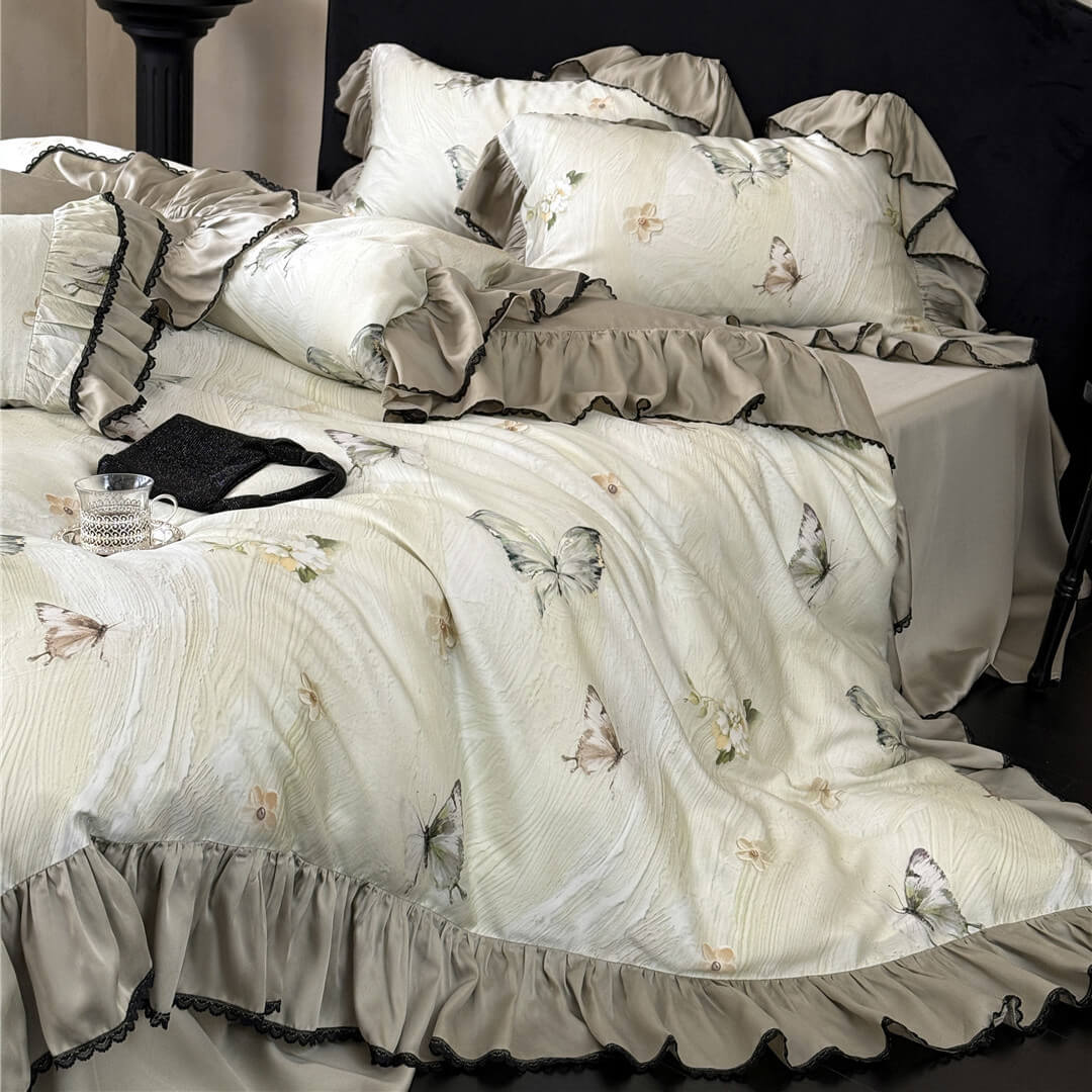 Close-up of the Soft TENCEL™ Butterfly Duvet Cover Set with Ruffles, highlighting the textured fabric and beige/grey ruffled trim with dark lace.