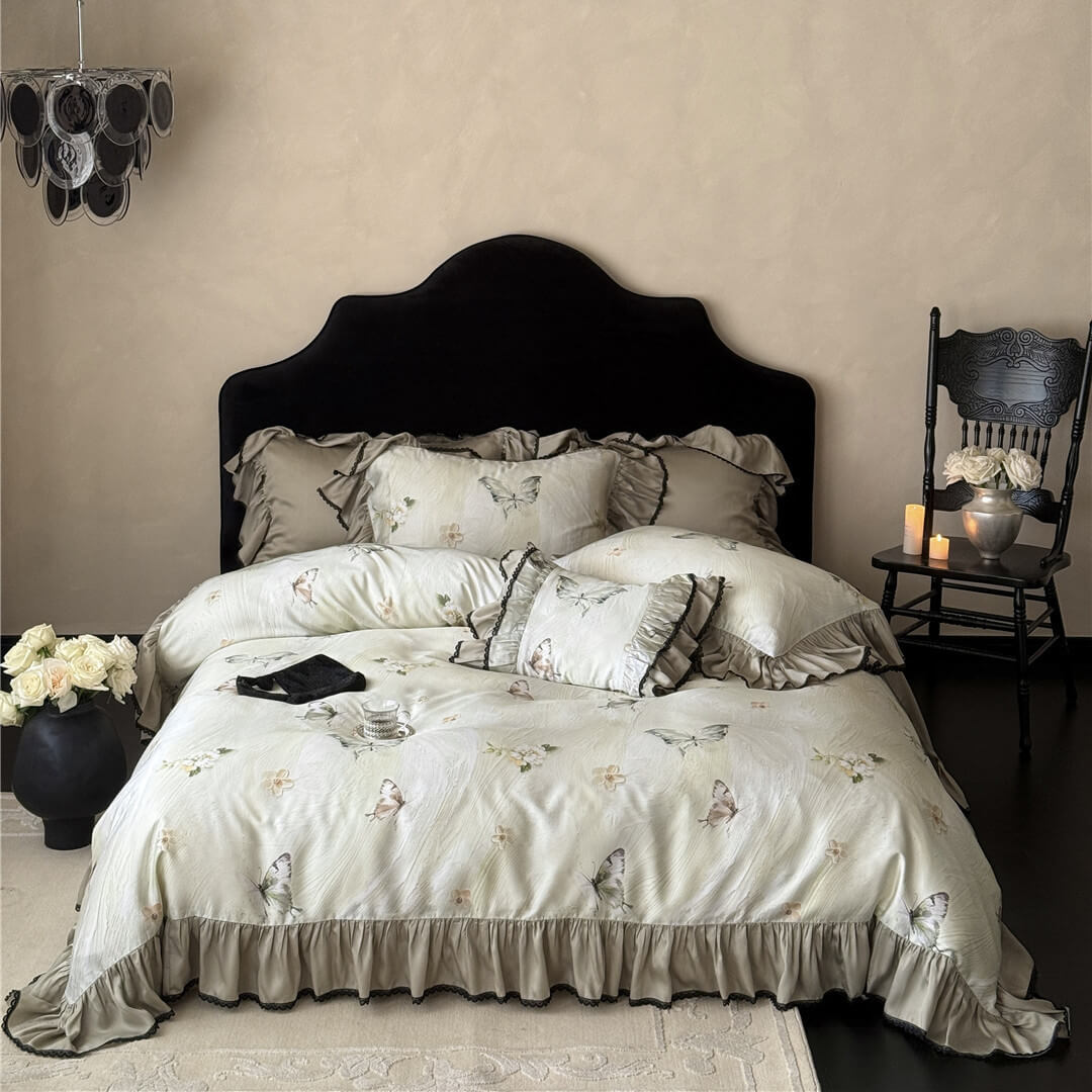 Full bedroom scene featuring the Soft TENCEL™ Butterfly Duvet Cover Set, with a dark chandelier and antique-style chair for scale and mood.