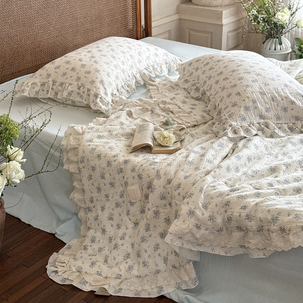 Overhead view of blue floral comforter and matching pillowcases