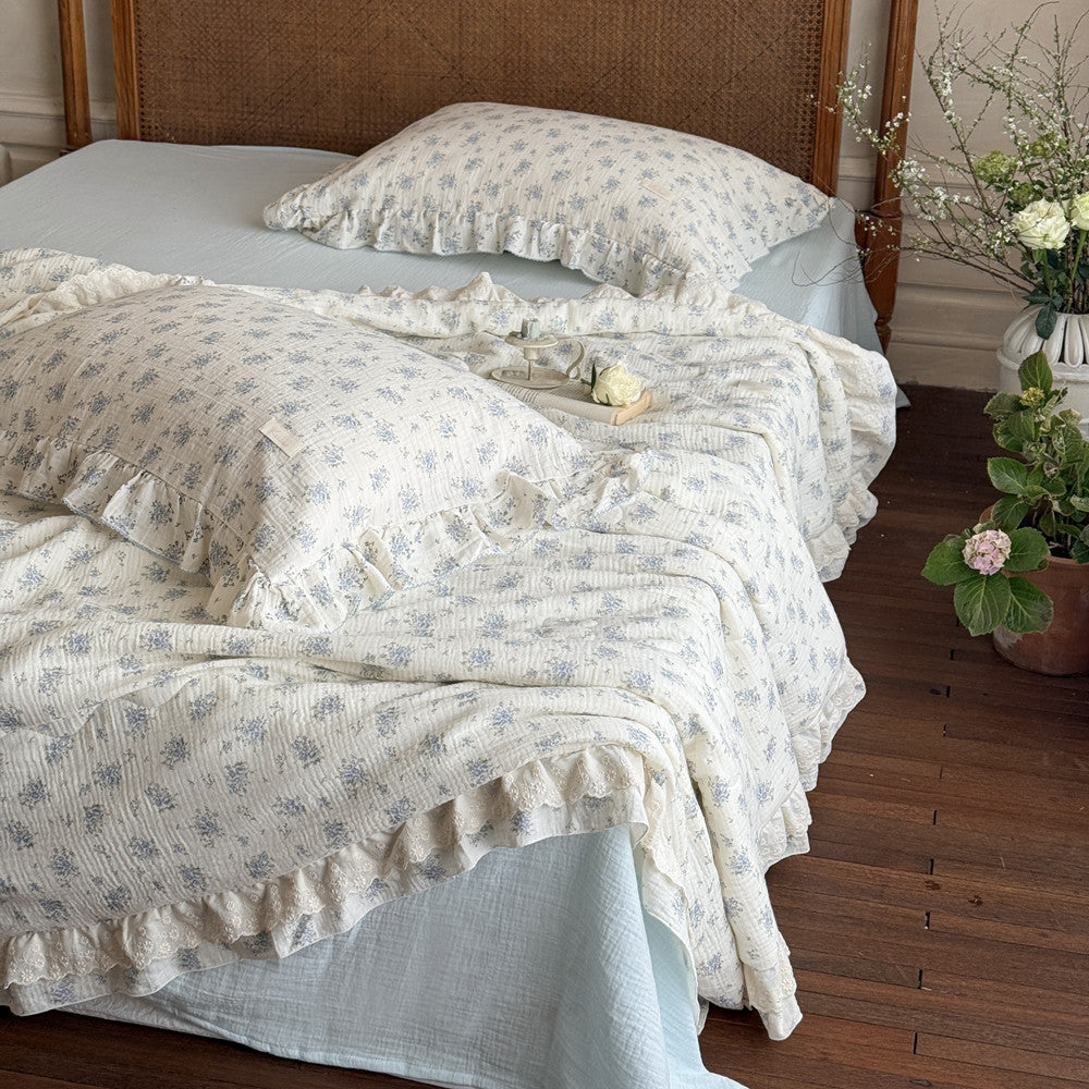 Floral cotton comforter styled with book and neutral decor