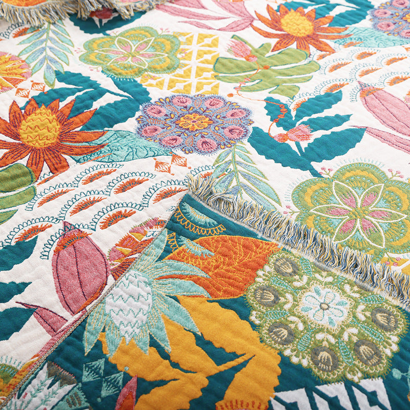 Close-up of tropical floral cotton throw blanket showing woven texture and fringe edge