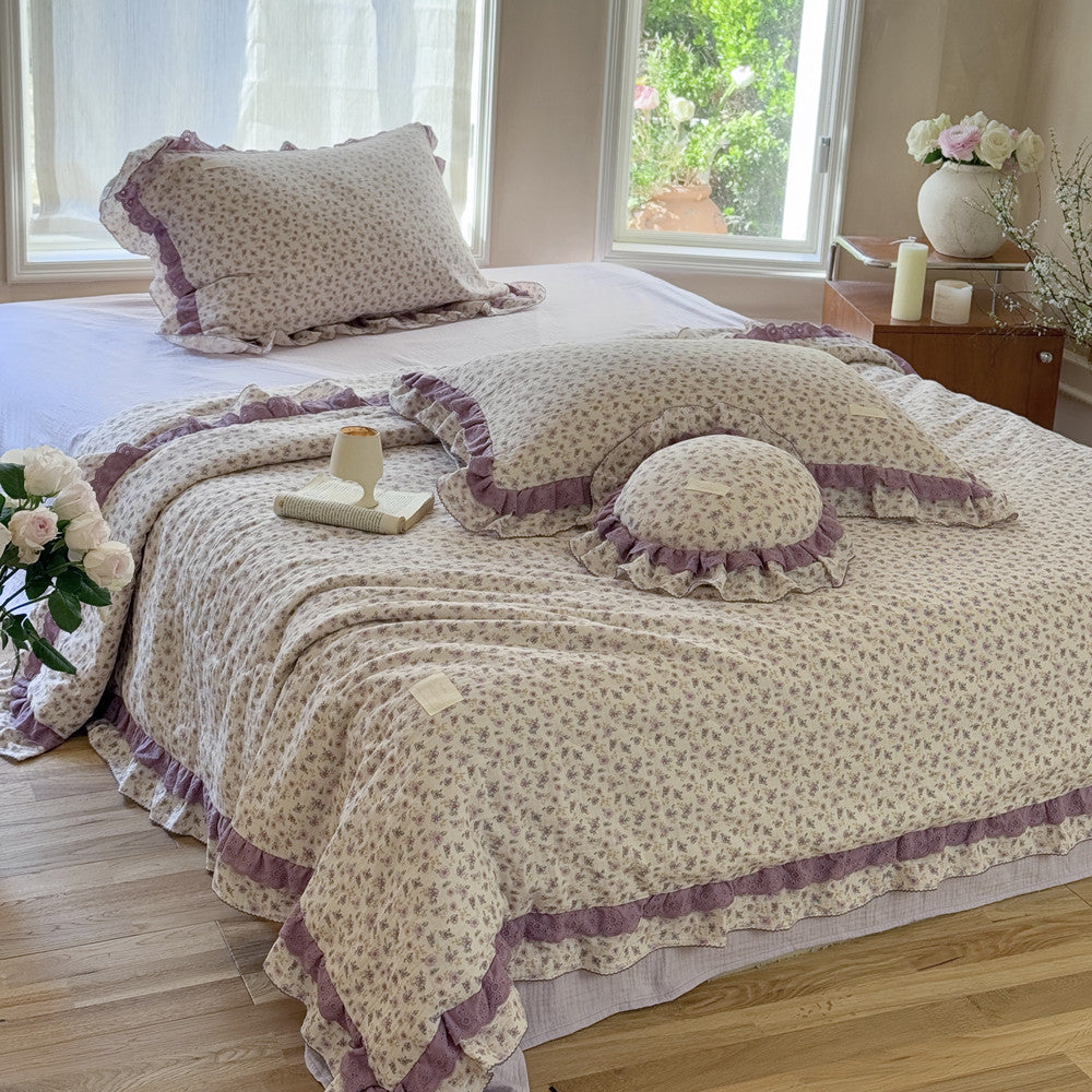 Relaxed cottage bedroom setting with lavender comforter and decor