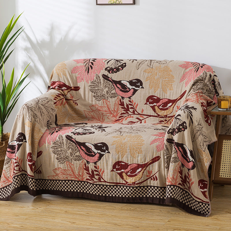 Bird and leaf patterned jacquard blanket used as a sofa cover