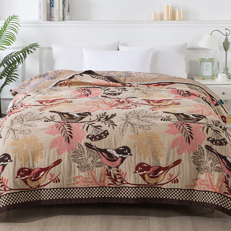 Autumn chickadee jacquard blanket styled on a bed with white pillows