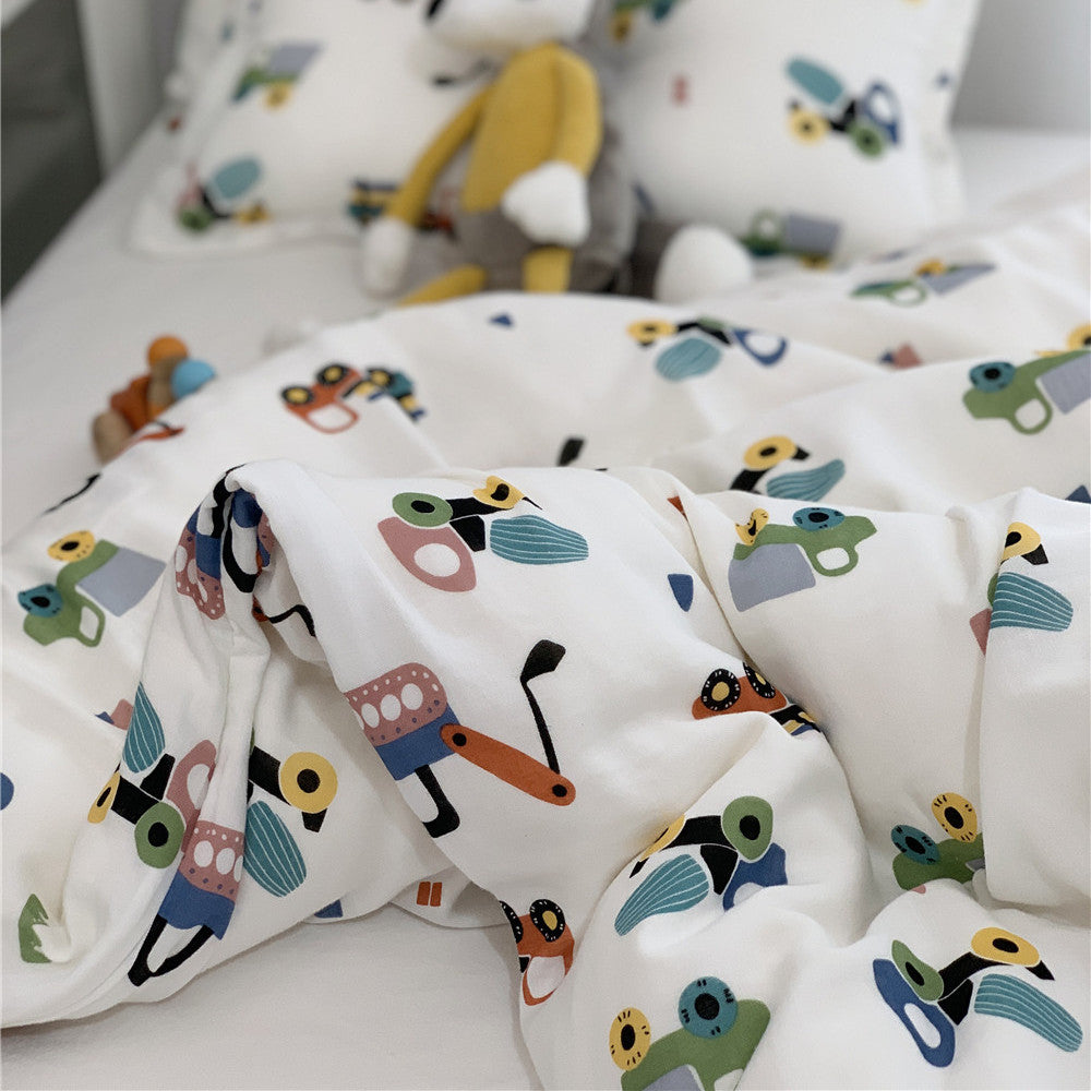 Close-up detail of the soft bamboo duvet cover fabric showing a playful cartoon vehicle and tractor design.