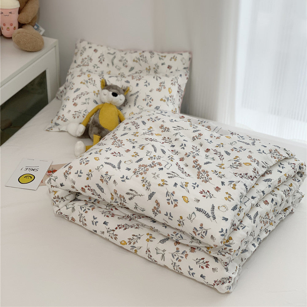 Neatly folded Bamboo Duvet Cover and pillow shams with a beautiful small floral and animal print, suitable for Twin Size Bedding.