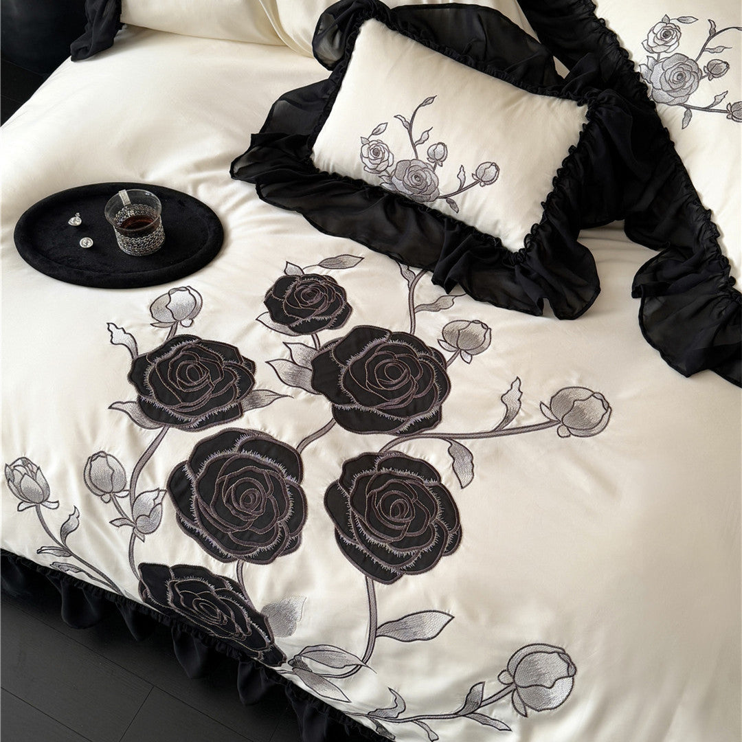 Floral embroidery and pillow design in black and ivory