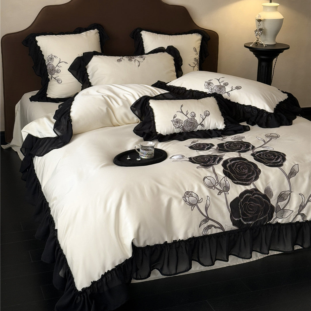 Complete black rose duvet cover set in ivory on bed