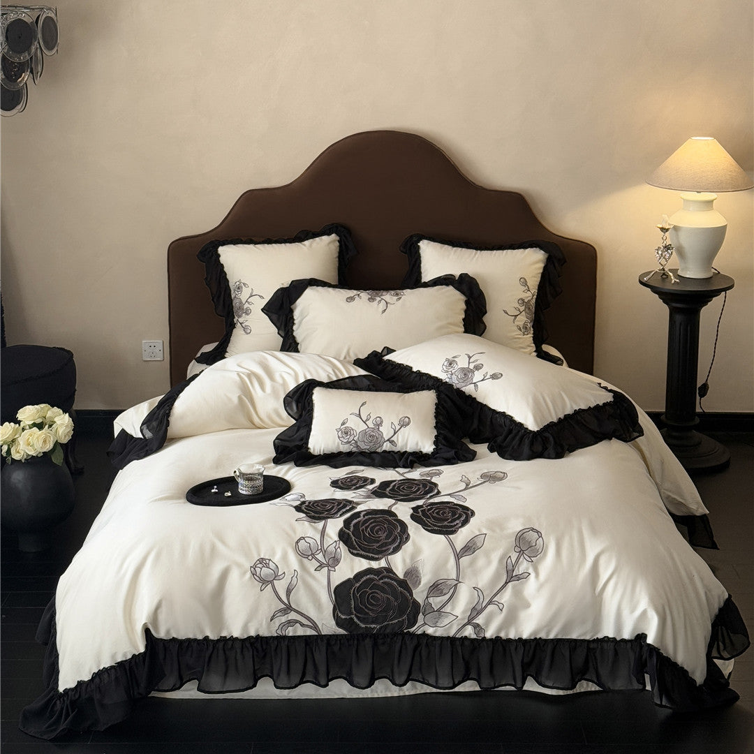 Black rose duvet cover set in ivory with full ruffled trim