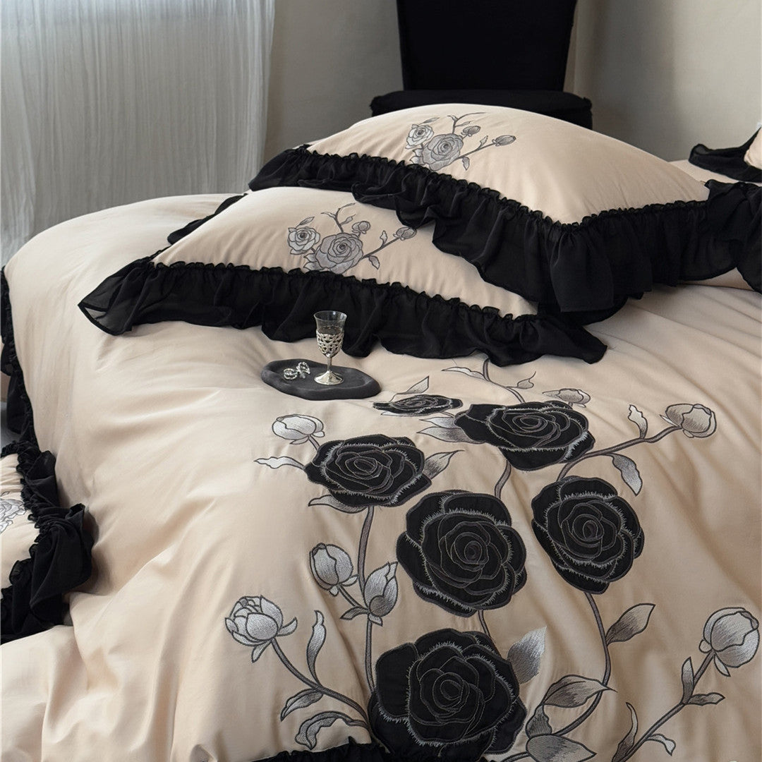 Ruffled pillowcases in warm taupe with black rose design