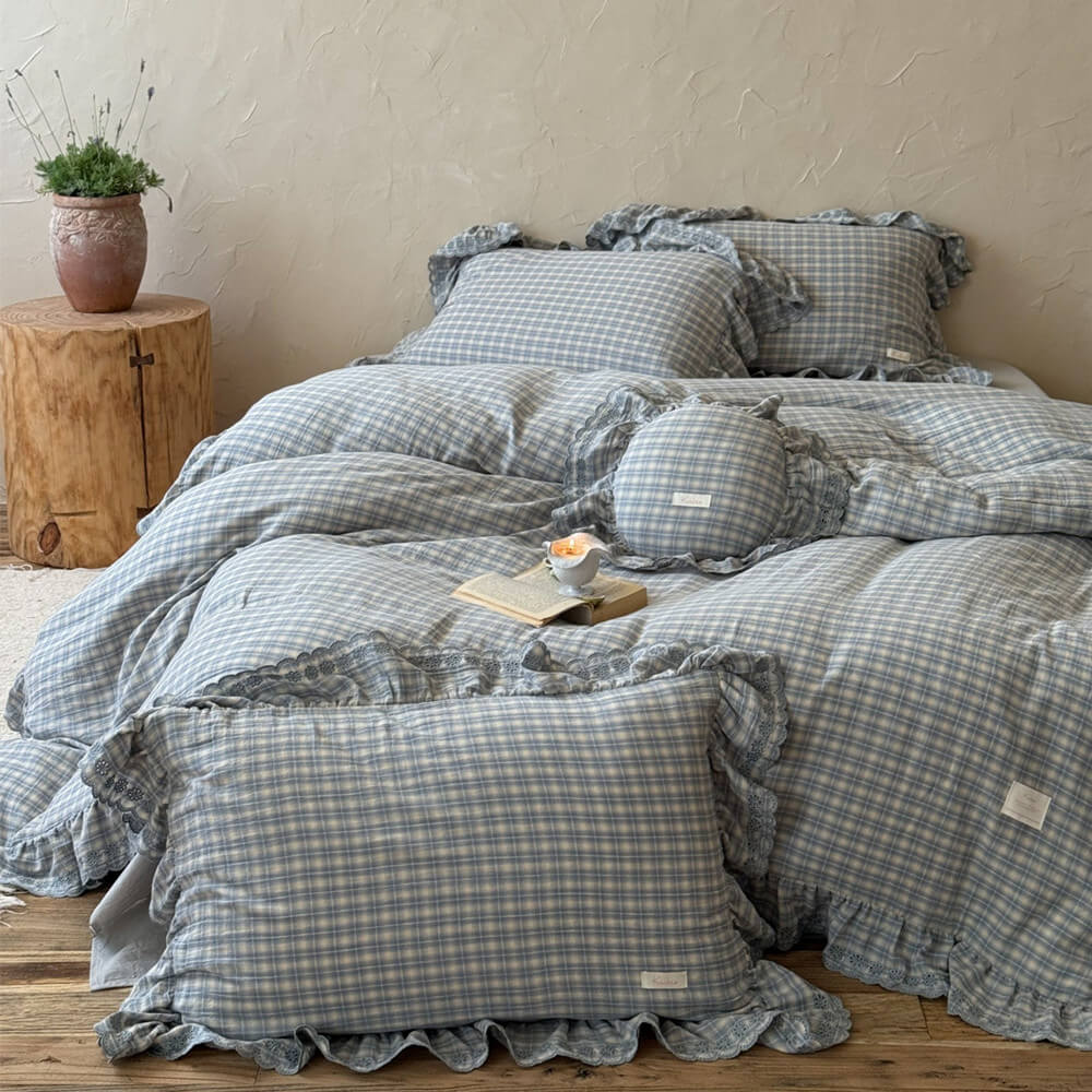 Modern bedroom featuring dusty blue plaid bedding set and light wood furniture