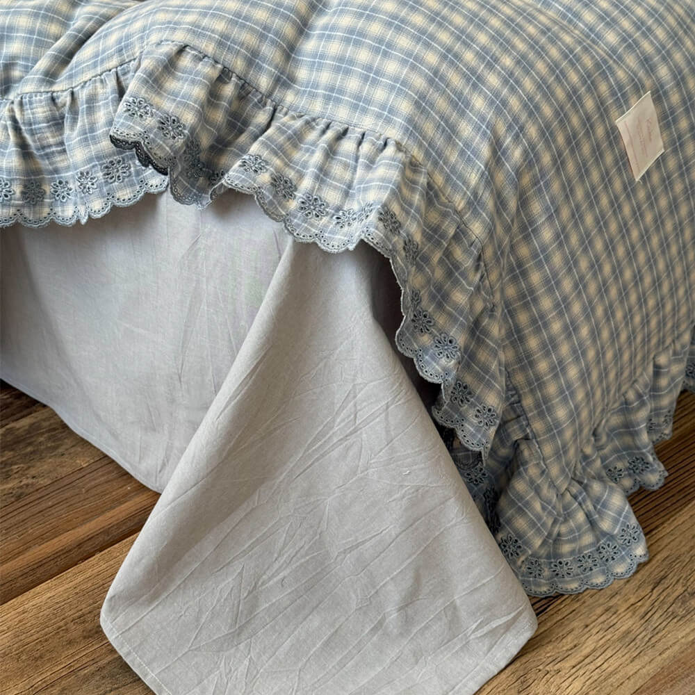 Ruffled bedding detail in blue plaid pattern, soft cotton muslin