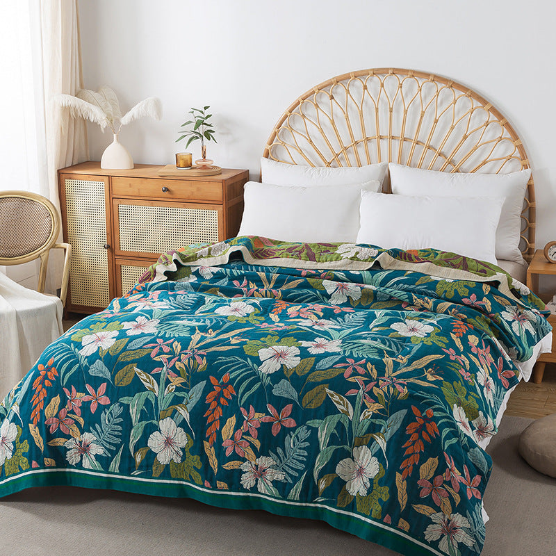 Botanical floral jacquard throw blanket styled on rattan bed