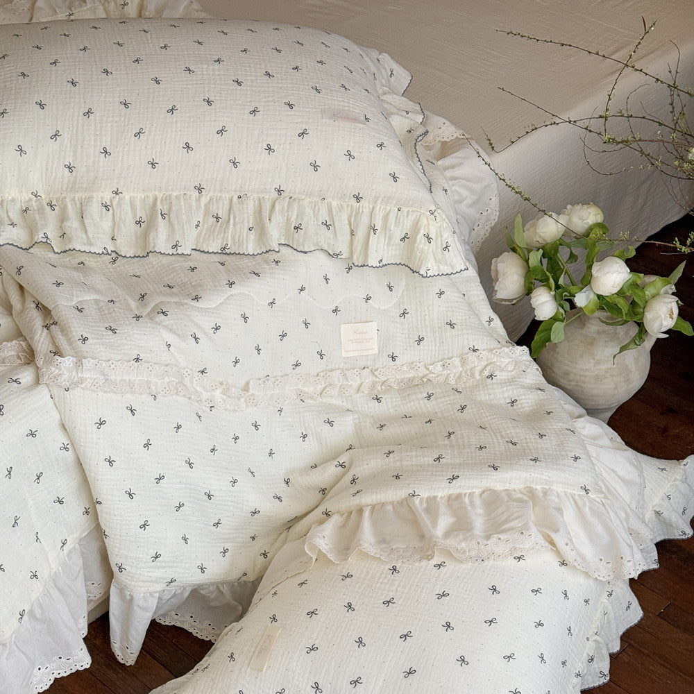 Pastel bedroom featuring bow comforter and lace decor