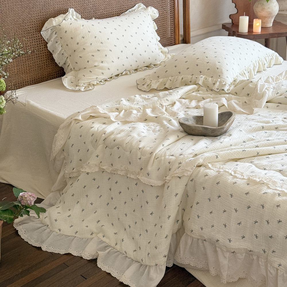 Full view of ruffled cotton comforter on single bed