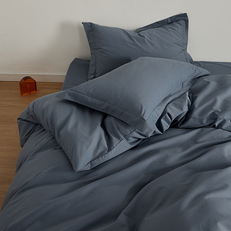 Stone Blue Brushed Cotton Duvet Cover Set on a bed, featuring the Soft & Cozy Bedding with two pillows.