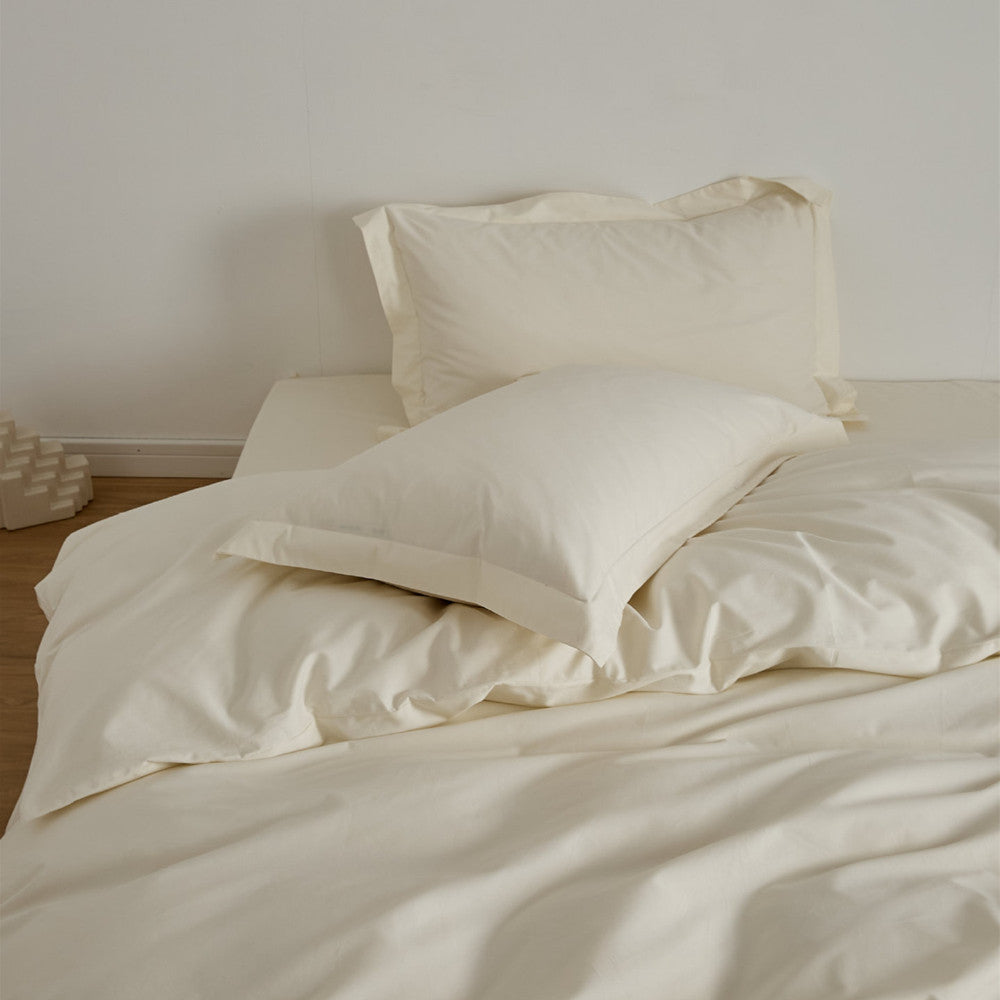 Ivory Brushed Cotton Duvet Cover Set on a bed, showing the Soft & Cozy Bedding with two pillows.