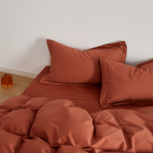 Detailed shot of a Rust Brushed Cotton Duvet Cover Set, highlighting the smooth texture of the Soft & Cozy Bedding.