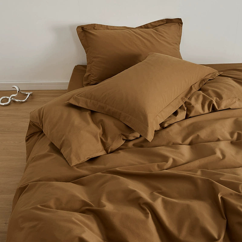 A brown brushed cotton duvet cover set on a bed, including a duvet cover, flat sheet, and pillowcases.