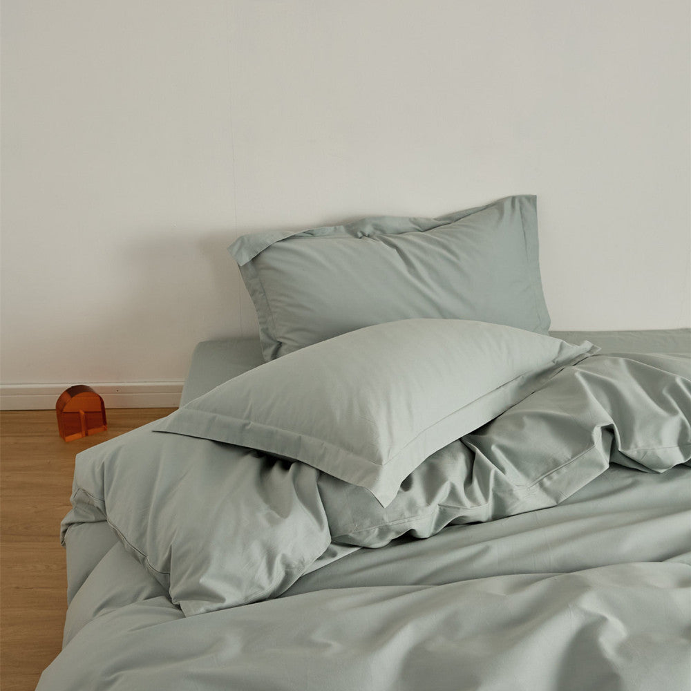 Sage green Brushed Cotton Duvet Cover Set on a bed, highlighting the Soft & Cozy Bedding with two pillows.