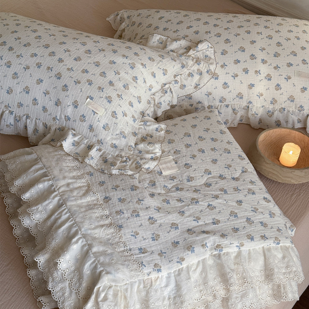 Rose floral cotton comforter paired with ruffled pillow on beige bedding