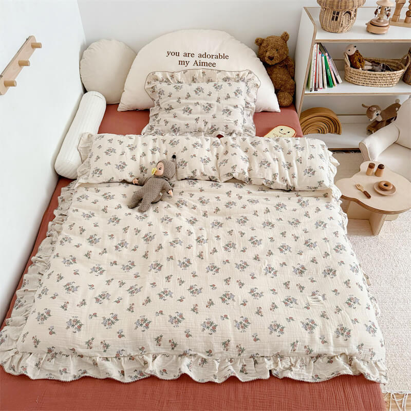 A close-up shot of a floral cotton duvet cover, showing the soft, textured cotton muslin fabric and the delicate floral print.