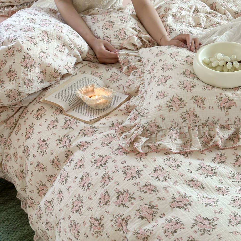 Detail shot of Pink Floral Cotton Gauze Duvet Cover and a ruffled sham, highlighting the soft crinkled texture and comfort of the Twin Size fabric.