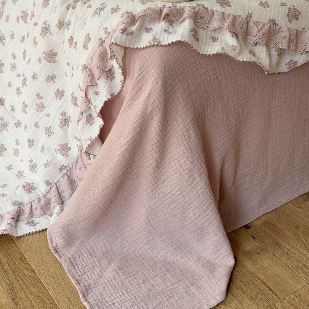 Blush-toned cotton gauze underlay beneath vintage comforter