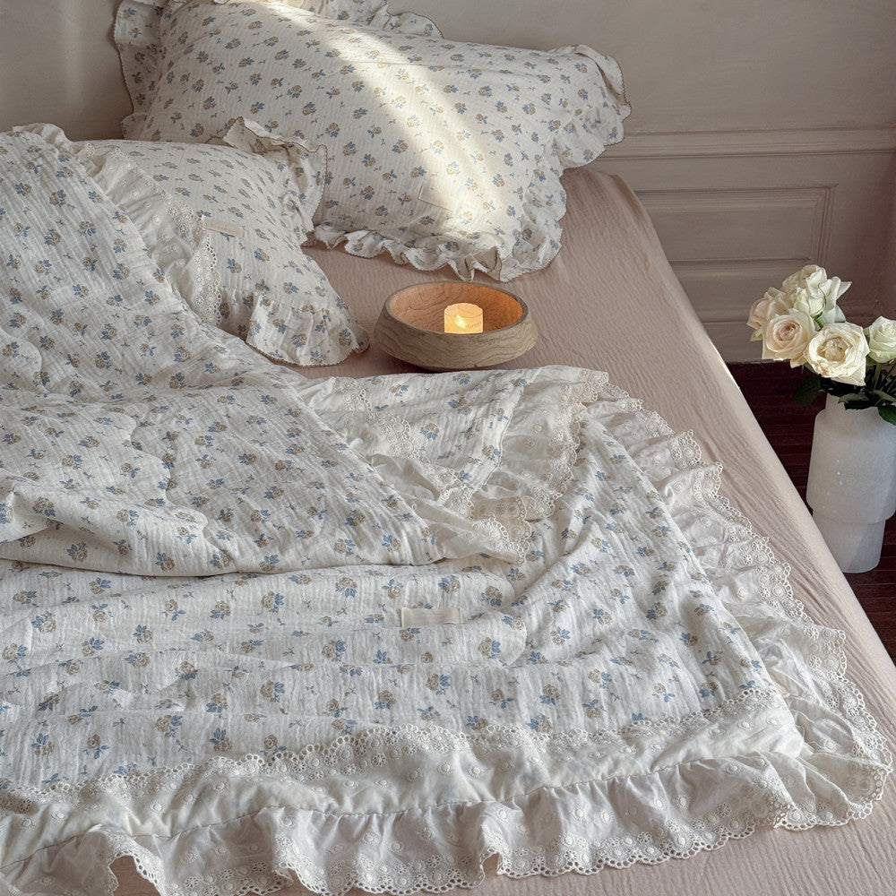 Bedroom scene with rose floral cotton gauze quilt and matching decor