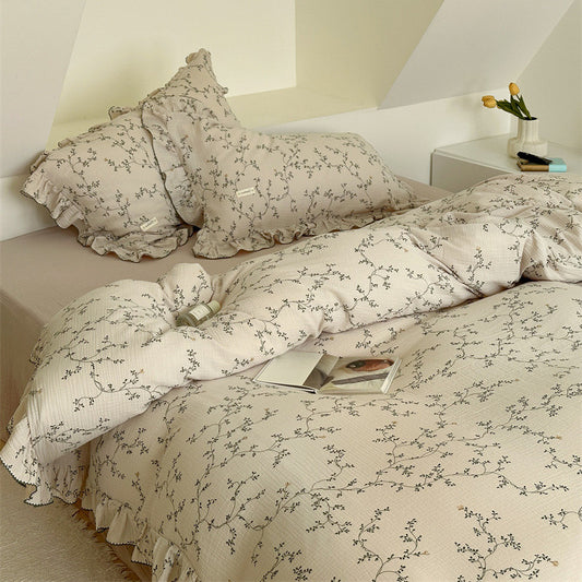 Nature Inspired Cotton Ruffle Duvet Cover Set with delicate Vine & Leaf Print on the bed.
