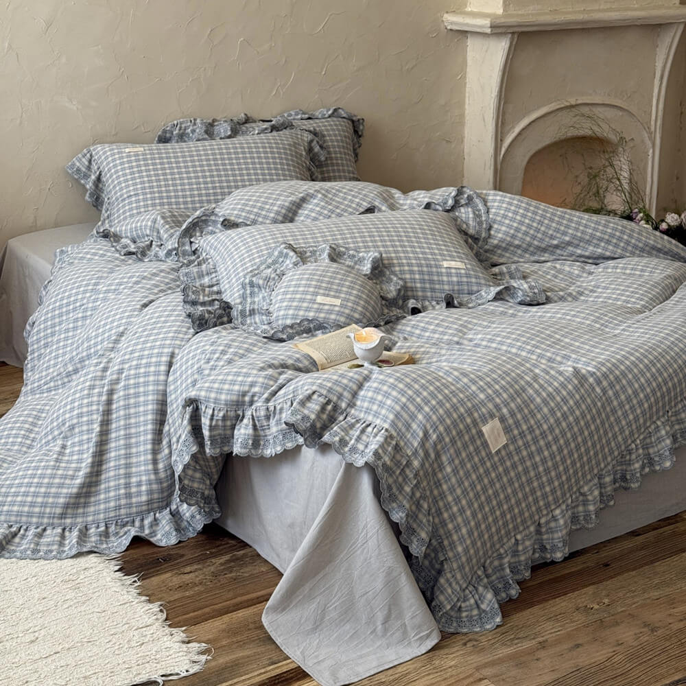 Dusty blue plaid bedding set with ruffled trim, cotton muslin, styled in a modern bedroom