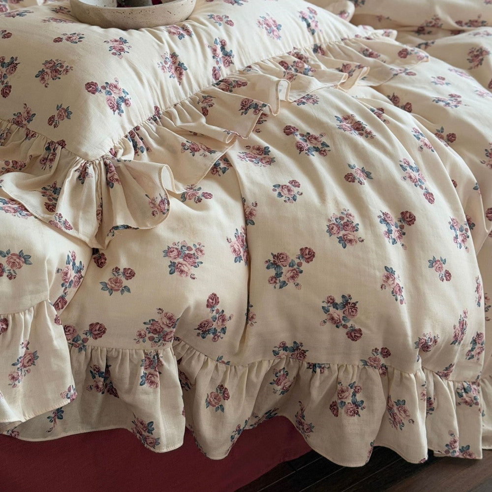 Detailed texture shot of the Ruffled Cotton Design duvet, focusing on the gathered fabric of the ruffle and the clear vintage rose floral pattern.