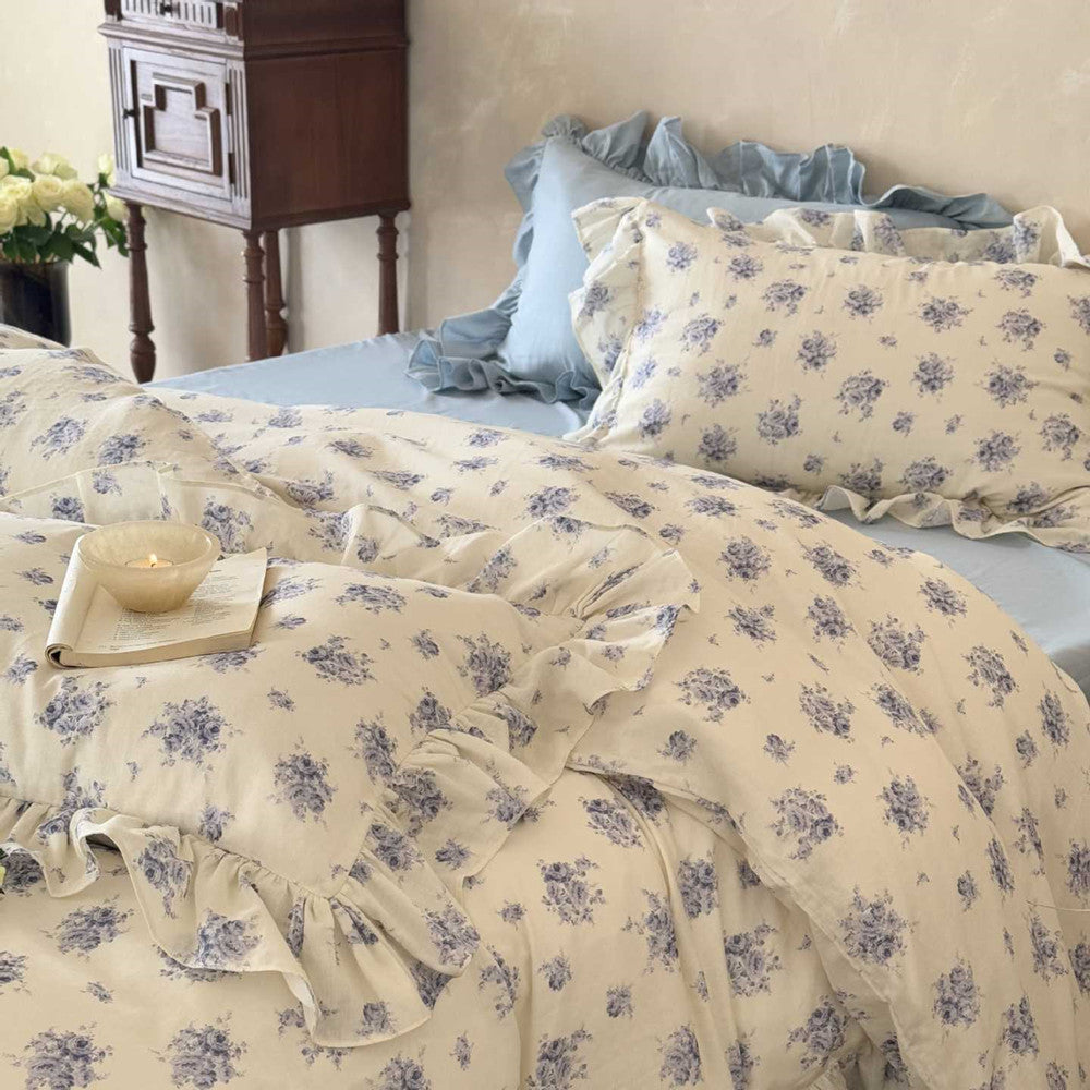 Duvet close-up: Blue cottage rose floral ruffled duvet cover and matching pillowcase with soft light.