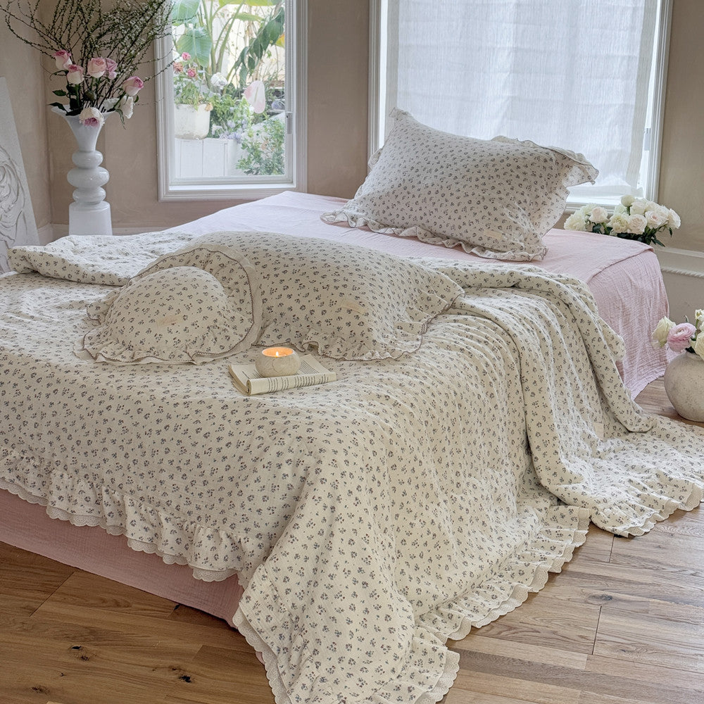 Full bed styled with romantic floral comforter and neutral surroundings for soft ambiance