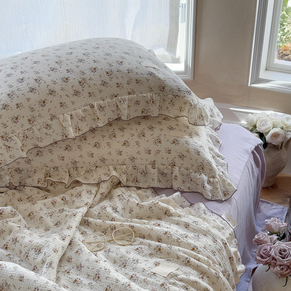 Lightweight floral comforter with lavender gauze sheets and soft ruffled edges